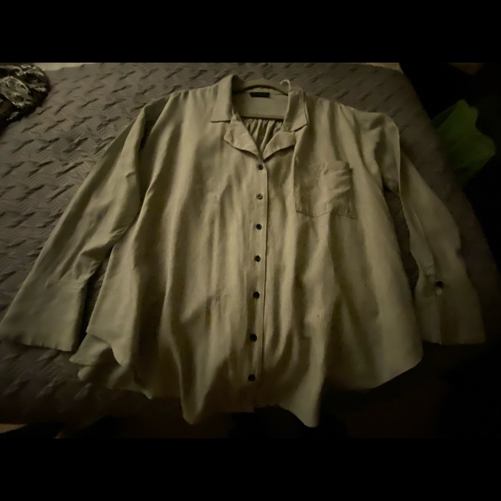 Long sleeve flared cuff button front blouse.